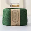 A skein of green bamboo fiber yarn labeled as 11 strands for knitting and crochet.