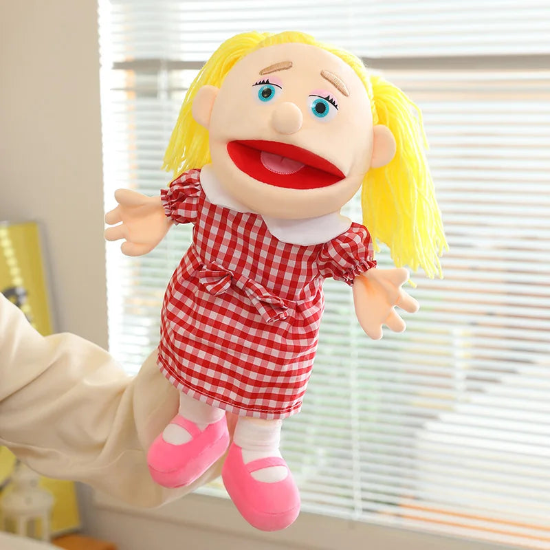 A yellow-haired plush hand puppet dressed in a red checkered dress and pink shoes.