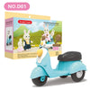 A light blue Stomle Family Moto toy scooter with a white forest animal figure.