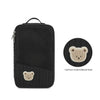 Black fabric diaper bag with a cartoon embroidered bear patch on the front