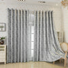 Gray tree bark jacquard blackout curtain panels hanging in a bright room.