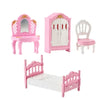 Pink miniature dollhouse furniture set including a vanity, cabinet, and bed for a bedroom