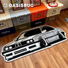 A black and white cartoon print plush carpet featuring a car design on a wooden floor.