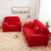 A vibrant red silky soft stretchable sofa cover displayed in a living room setting.