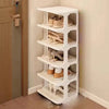 A white stackable vertical shoe rack with multiple tiers is shown next to a wooden door.