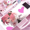 Anime character illustration on a pink mouse pad with surrounding desk accessories