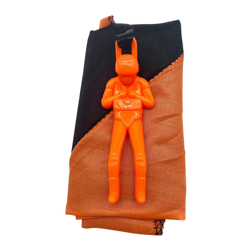 An orange hand-throw parachute toy with a mini soldier figure for outdoor kids play.
