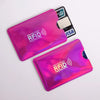 A close-up view of a vibrant pink RFID protection card sleeve and a black credit card inside.