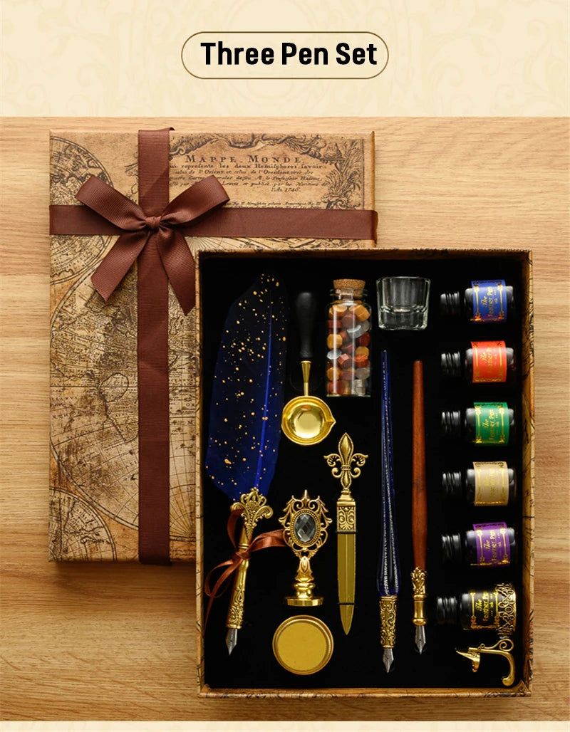A wooden box containing a three-pen set with various fountain pens and a wax seal stamp kit resting on an old map.