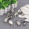 Stainless steel swivel pulley with hook in various sizes and angles on a gray fabric background.