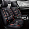 Black leather car seat covers with orange stitching and headrest covers shown in a vehicle interior.