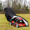 A red outdoor push mower with a black protective cover is resting on green grass.