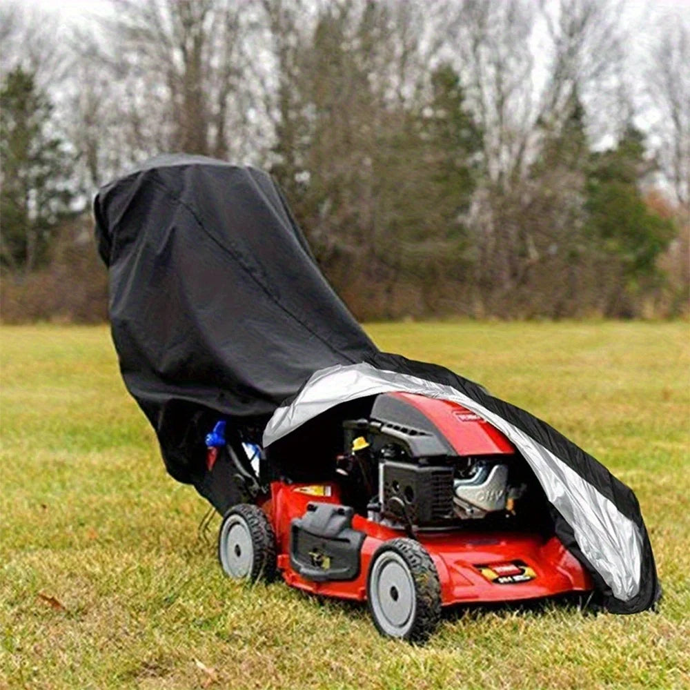 A red outdoor push mower with a black protective cover is resting on green grass.