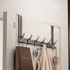 A silver over-the-door organizer rack with eight hooks mounted on a light gray wall.