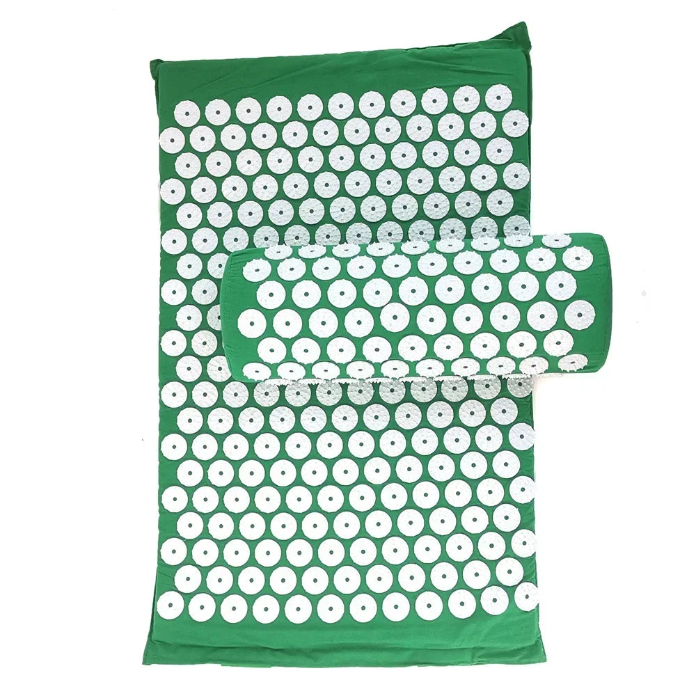 A green acupressure mat and pillow set with white dots for pain relief and relaxation.