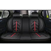 Black PU leather car seat covers with red stitching installed on a vehicle interior.