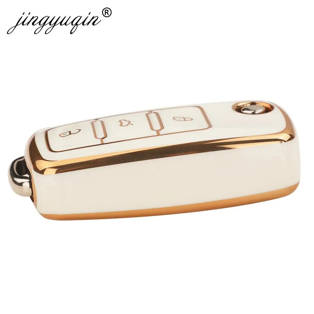 A white TPU silicone car key case with gold accents, featuring multiple buttons for flip keys.