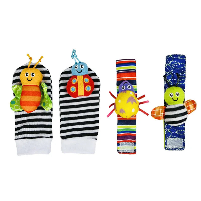 A set of soft baby rattles featuring an orange and green character on a black striped wrist finder and a blue patterned foot 