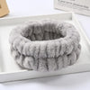 A gray microfiber wrist sweatband and scrunchies for face washing are displayed in a white box.
