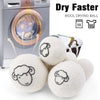 A set of six white wool drying balls next to a laundry machine, demonstrating a faster drying method.