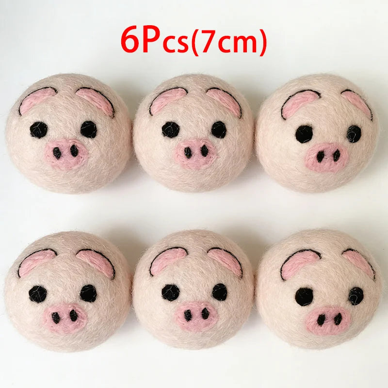 Six natural wool dryer balls shaped like pigs, measuring 7cm each.