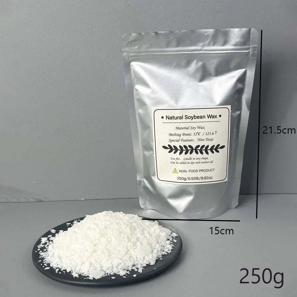 A white bag of Natural Soybean Wax flakes next to a pile of the same wax on a dark plate.