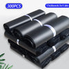 A stack of black self-seal poly mailer bags for shipping, packaged in rolls.