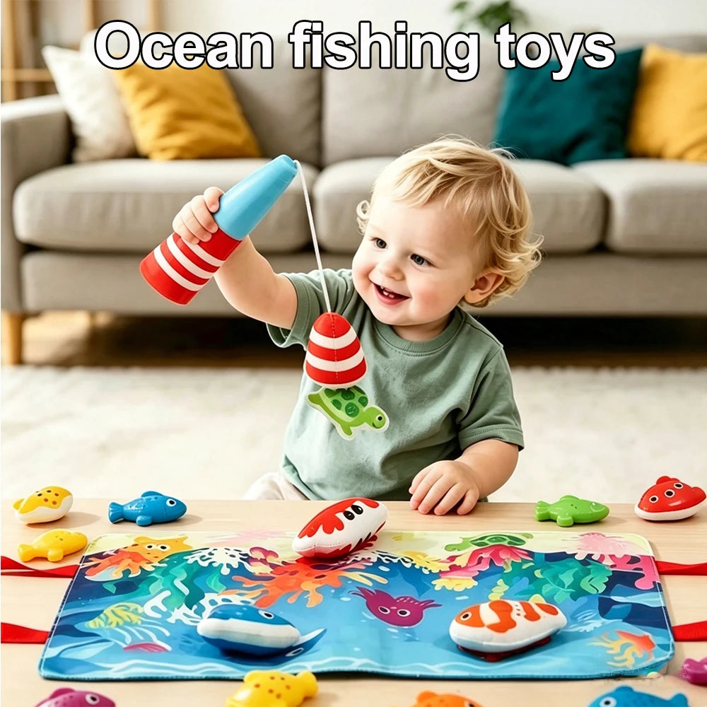 A smiling toddler is playing with an ocean fishing toy featuring colorful fish and a green frog on a blue mat.