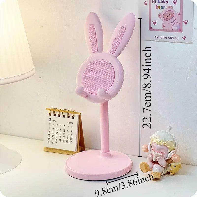 A pink rabbit mobile phone and tablet stand with a pink base and upright support.
