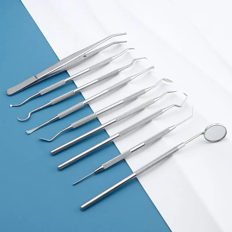 A set of premium stainless steel dental care tools for oral hygiene laid out on a blue and white surface.