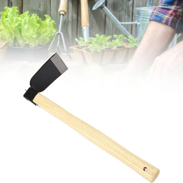 A wooden-handled garden hand hoe with a black blade, shown against a blurred background of gardening tools and plants.