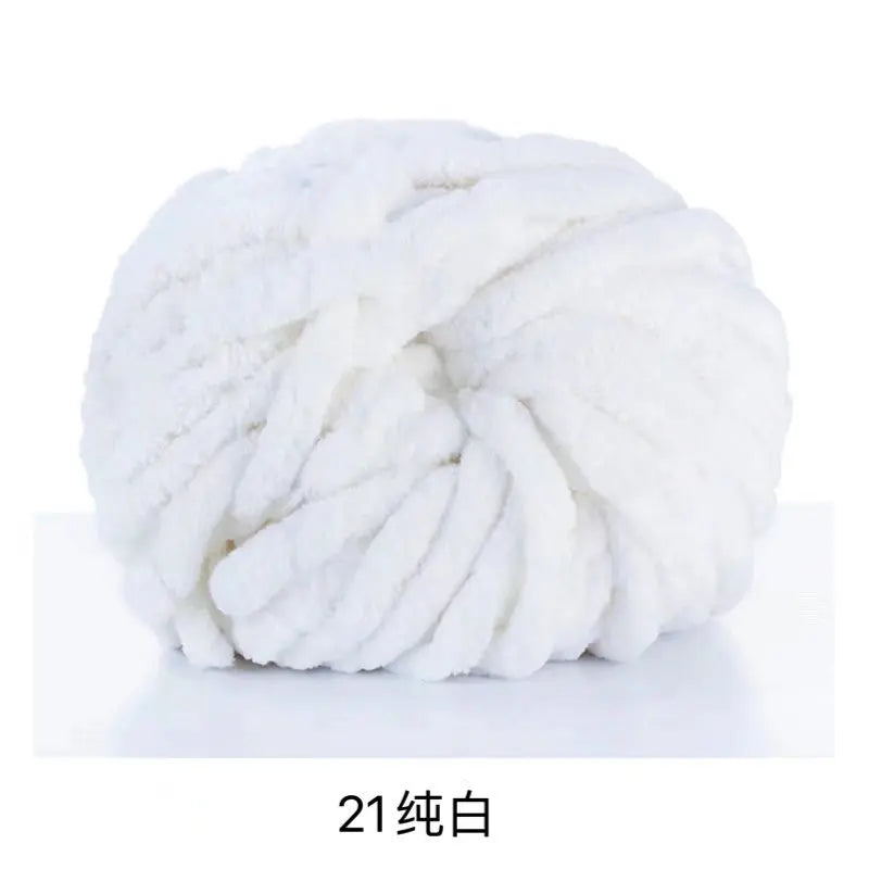 A ball of white chunky acrylic yarn used for knitting and crochet