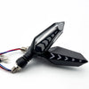 A black motorcycle turn signal indicator with a clear lens and electrical connector.