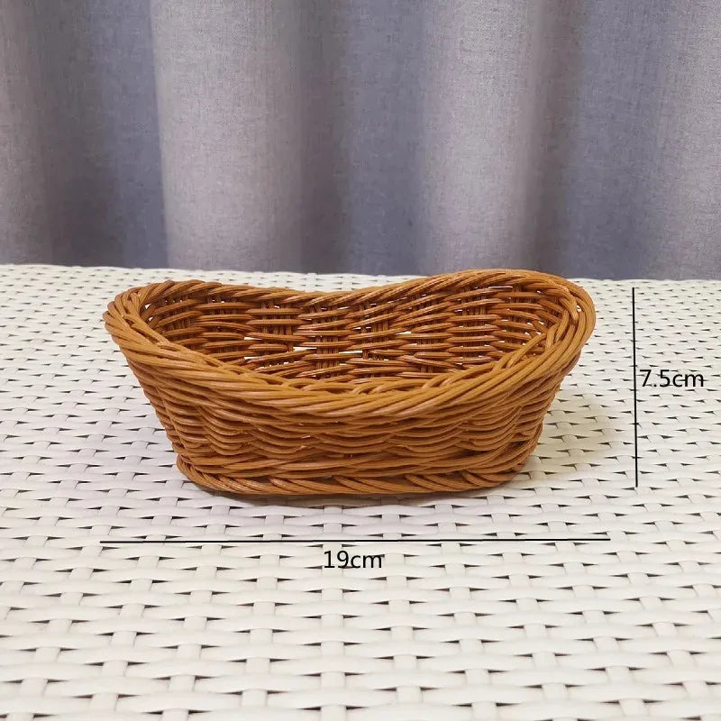 A handwoven wicker serving basket with a heart shape is displayed on a white surface.