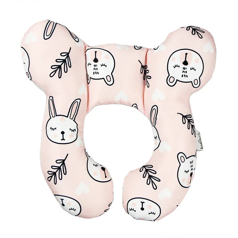 Pink fabric head and neck support pillow featuring cute animal faces for baby travel
