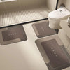 A modern bathroom featuring a toilet and floor mats for natural diatomium mud protection.