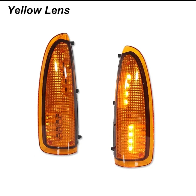 A pair of yellow lens amber LED side mirror turn signal lights for a vehicle.