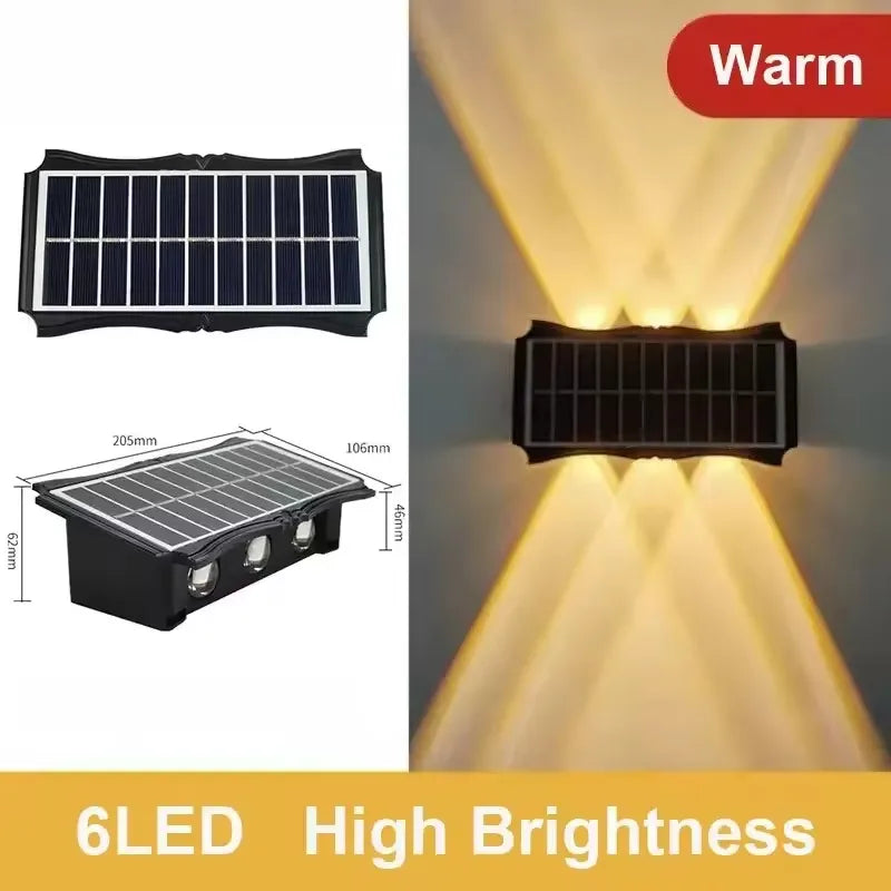 A black solar powered LED wall light panel illuminating a wall with warm light.