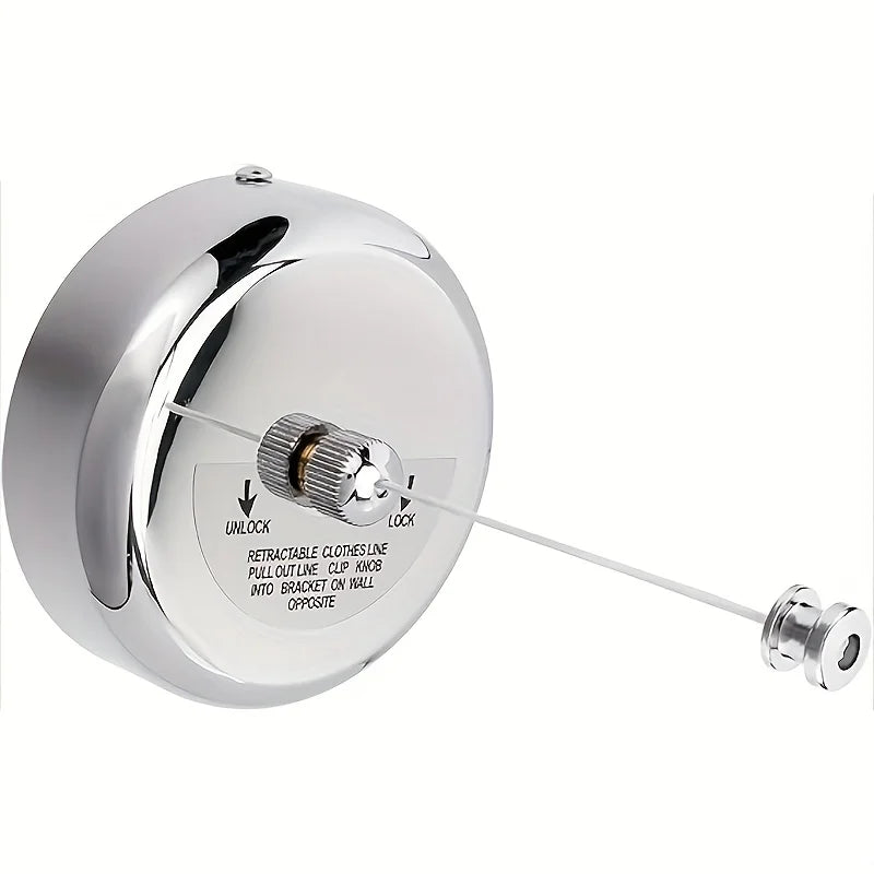 A round, chrome wall-mounted clothesline with a retractable line extending from it.