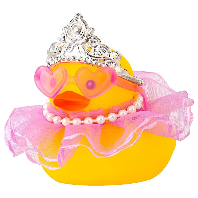 A yellow rubber duck decoration adorned with a silver crown, pink sunglasses, and a pearl necklace.