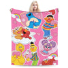 A pink flannel throw blanket featuring characters from Sesame Street and Friends