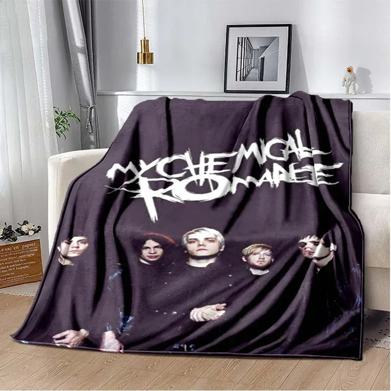 A dark gray fleece throw blanket featuring a graphic design of My Chemical Romance band members.