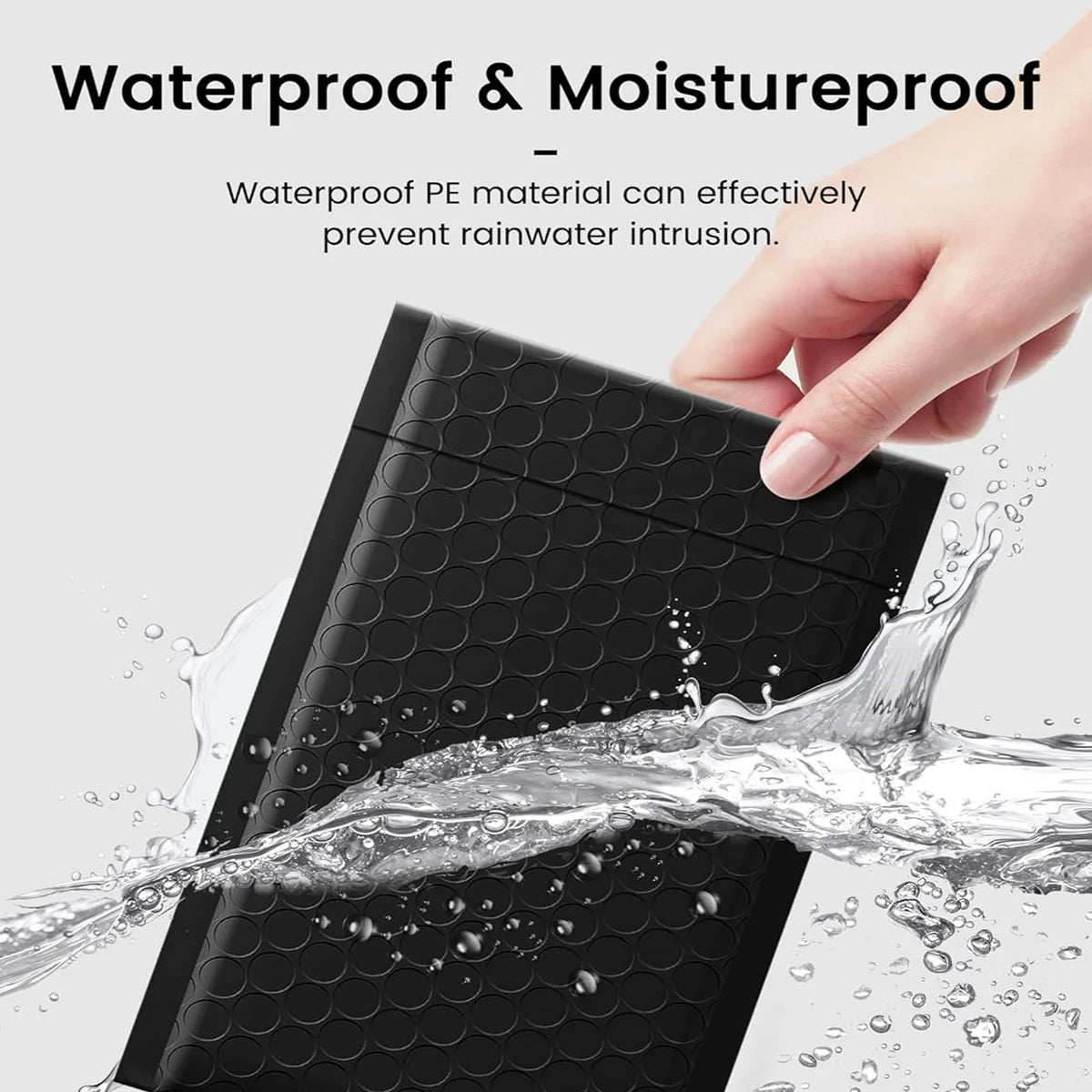 A hand is shown interacting with a black, waterproof bubble mailer, demonstrating its moistureproof sealing capability.