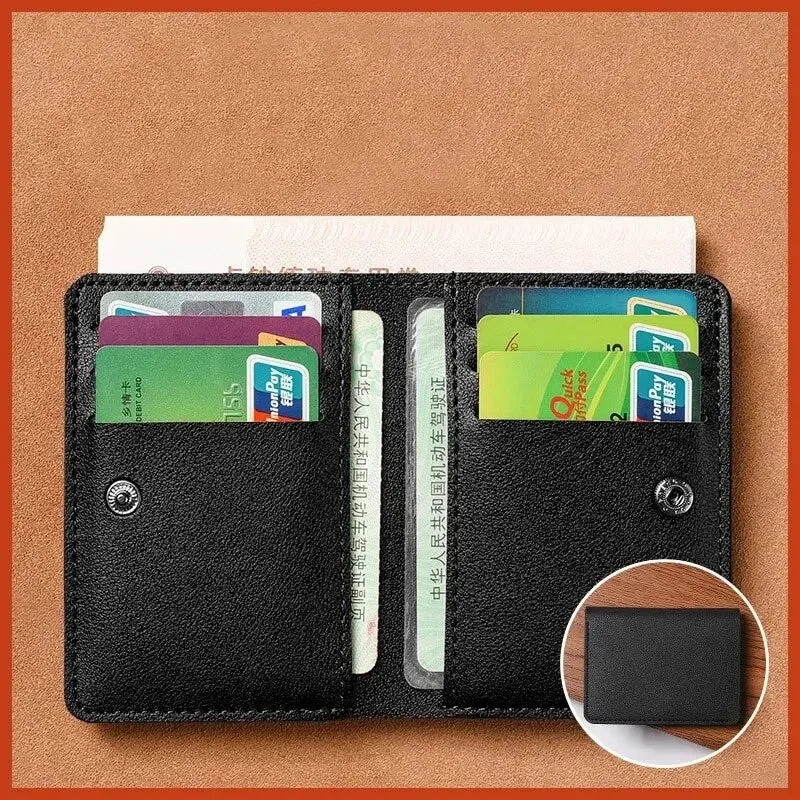 A black compact wallet holding several credit cards and a bank note on a brown surface.