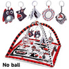 A baby play gym mat with various hanging toys including an owl, a cat, and other animal figures.