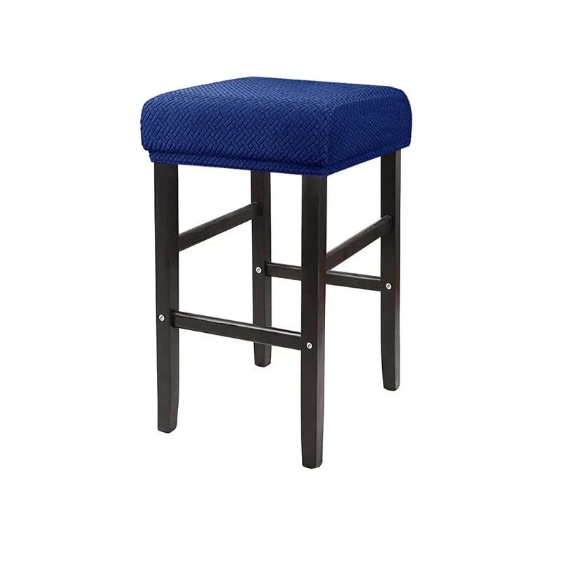 A navy blue stretchy jacquard bar stool slipcover with an elastic edge.
