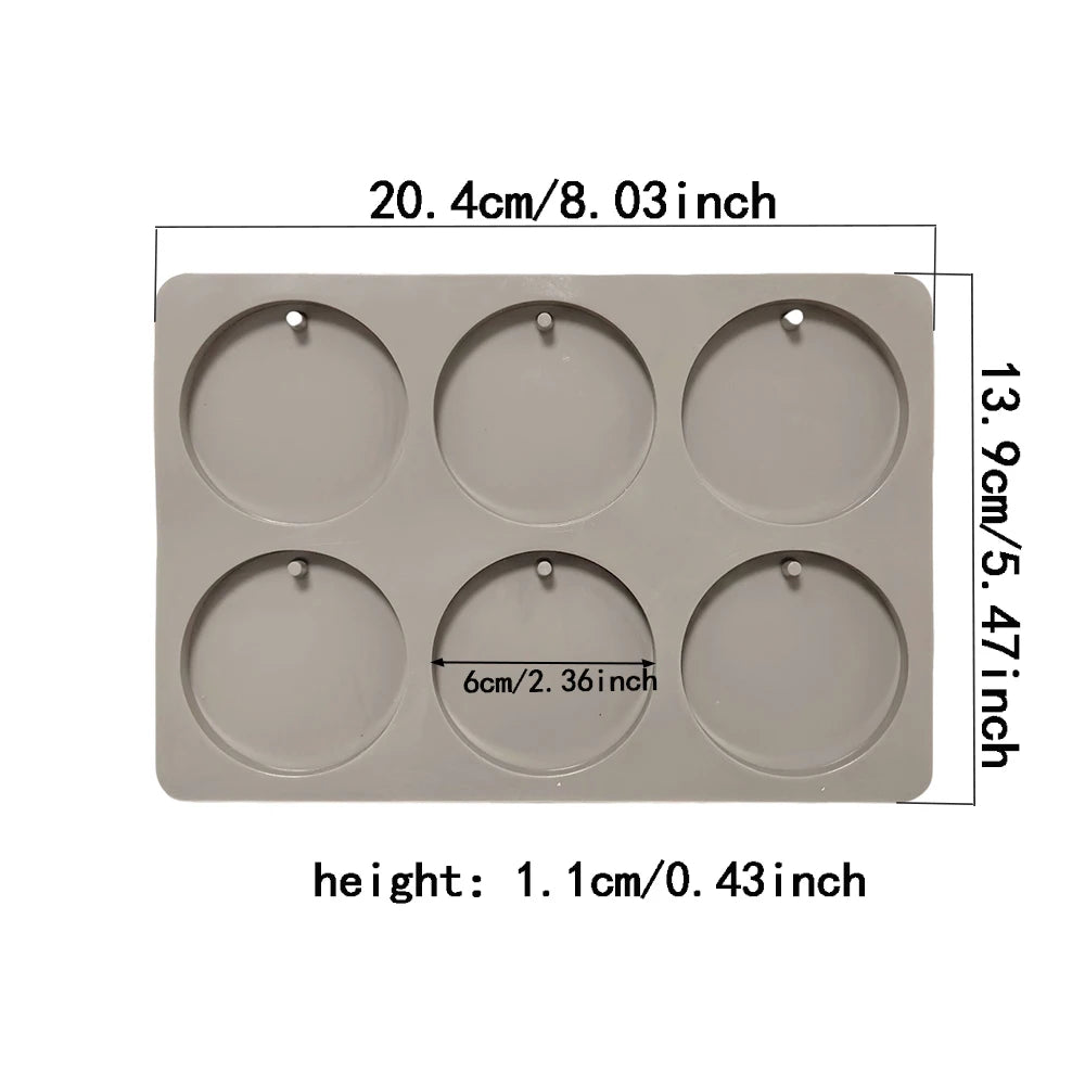 A rectangular silicone mold with six circular cavities for making soap or aromatherapy discs.