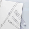 A transparent foldable plastic ruler with millimeter markings is shown on a white background.