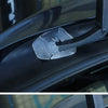 Close-up shot of a silicone windshield wiper arm hole cover installed on a car, showing its texture and fit.