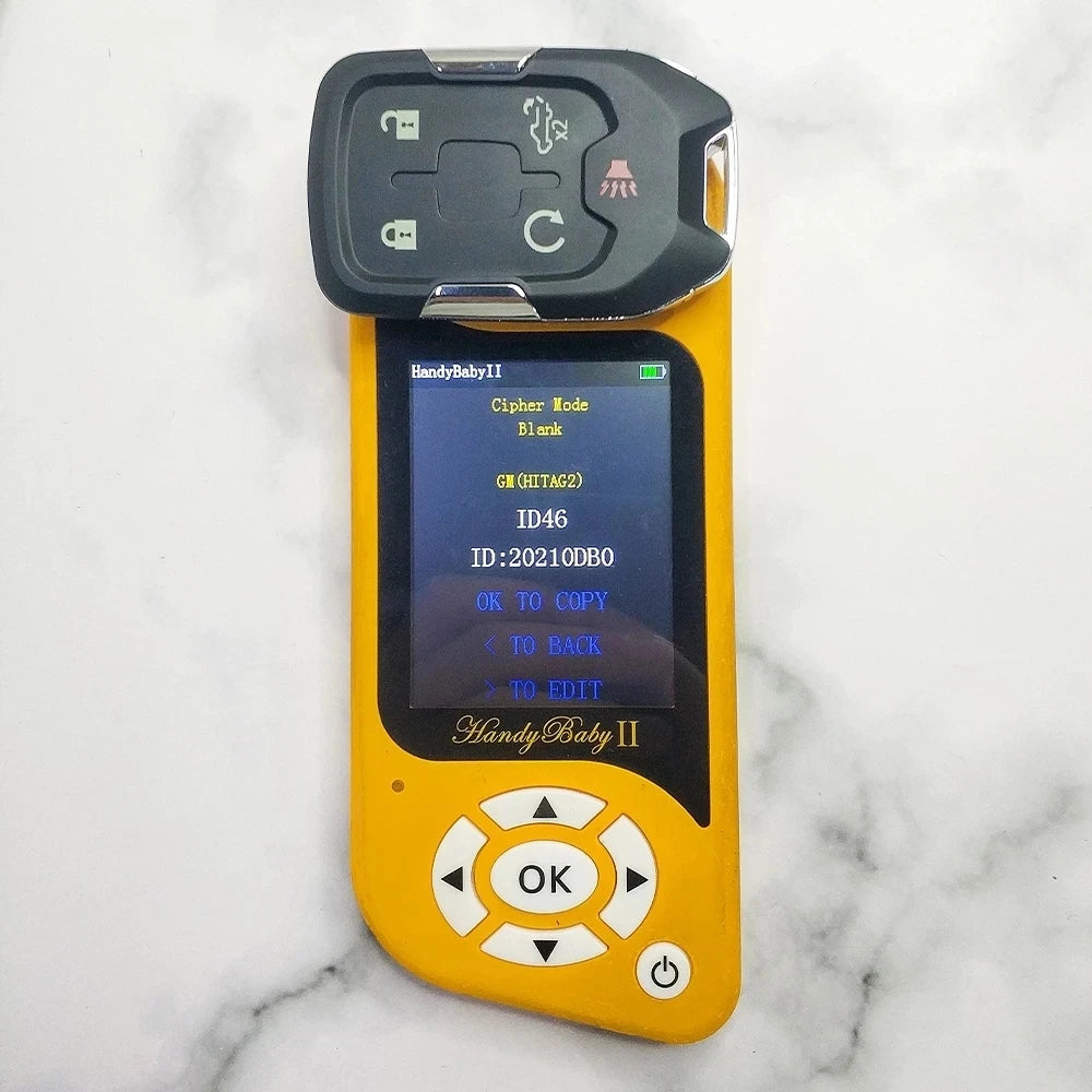 A yellow handheld remote key for a vehicle, featuring a black grip and an LCD screen.